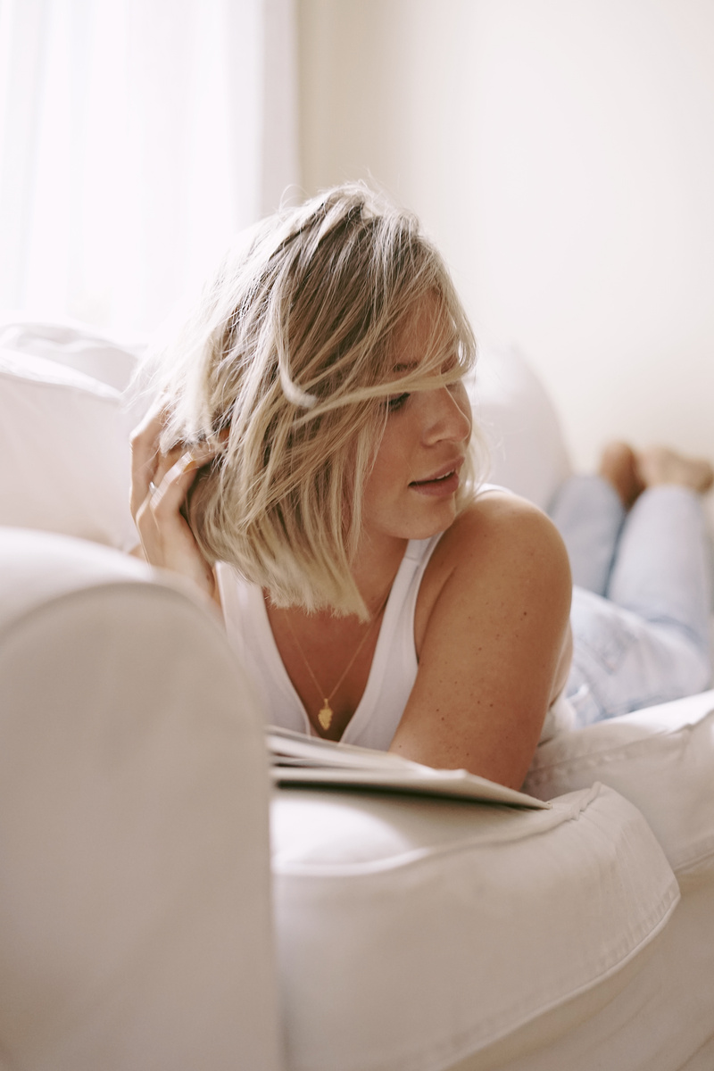 Woman in White Tank Top Reading Book